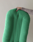 Lightweight Moss green infant lounger lifted with one hand