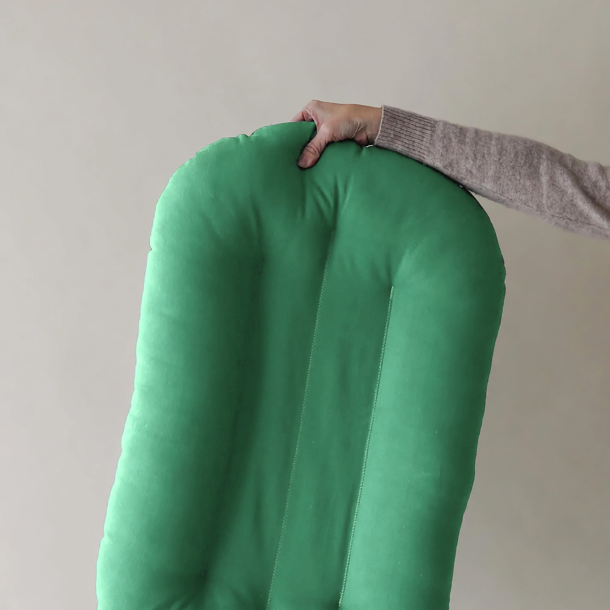 Lightweight Moss green infant lounger lifted with one hand